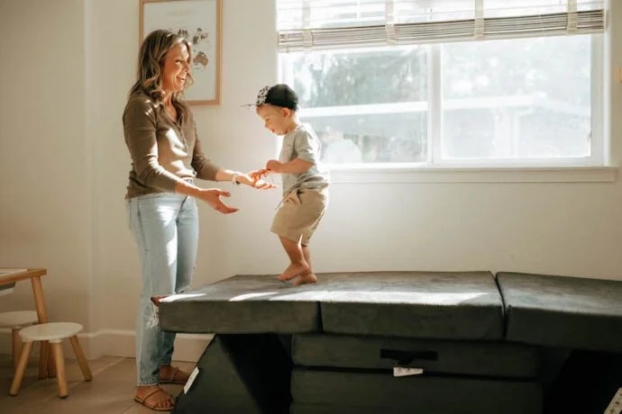 mom and toddler playing on leo mats