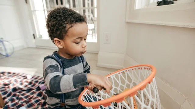 Curious child with toys